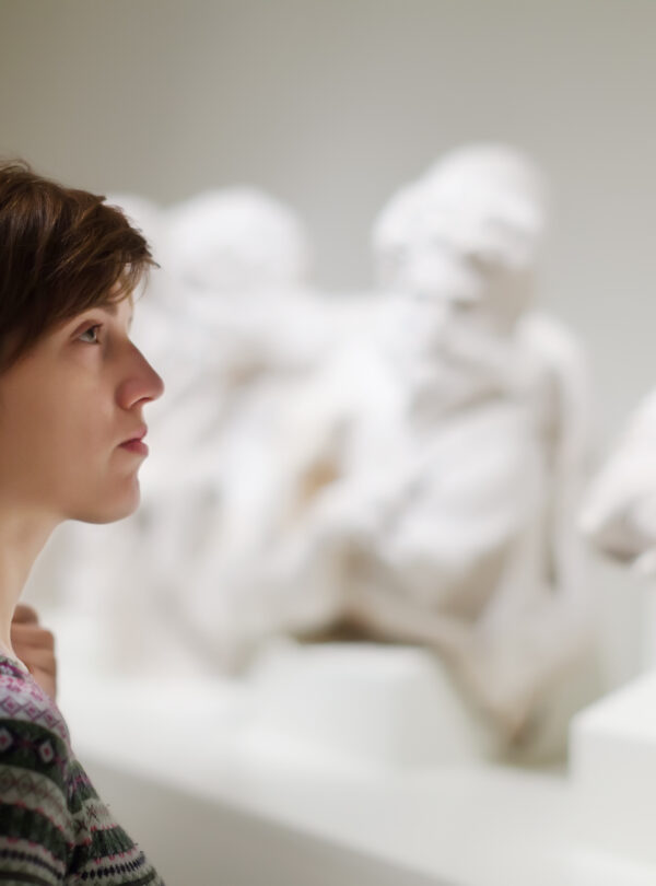 woman looking ancient sculptures